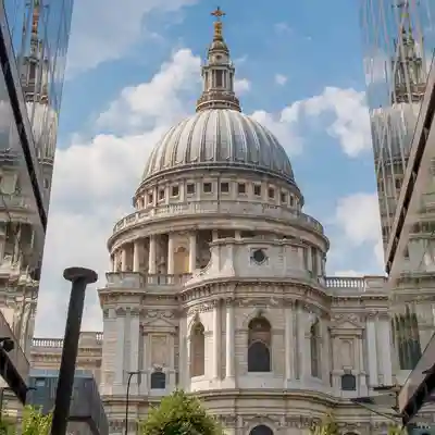 Architecture St. Paul's Cathedral looking between modern office buildings.