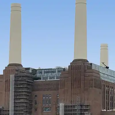 The art deco styled brick-built exterior of the building with iconiic white-painted white chimneys.