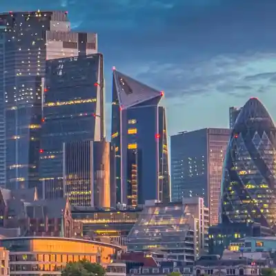 Dusk view of tall buildings across the Thames.