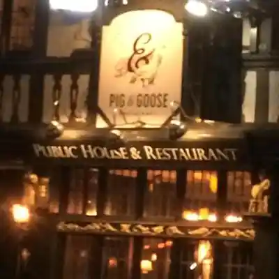 The George Holborn The illuminated front of the pub at night.