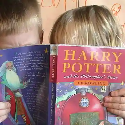 Harry Potter Children eagerly reading a Harry Potter book.