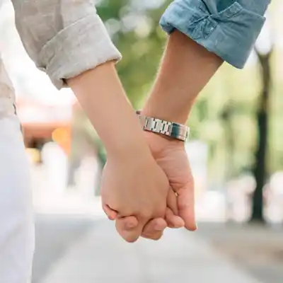 Couple walking down a London street hand in hand.