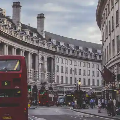 The curve of the street at the Piccadilly end with red London Bus.