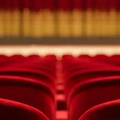 Theatre Stage curtain with the back of seats.