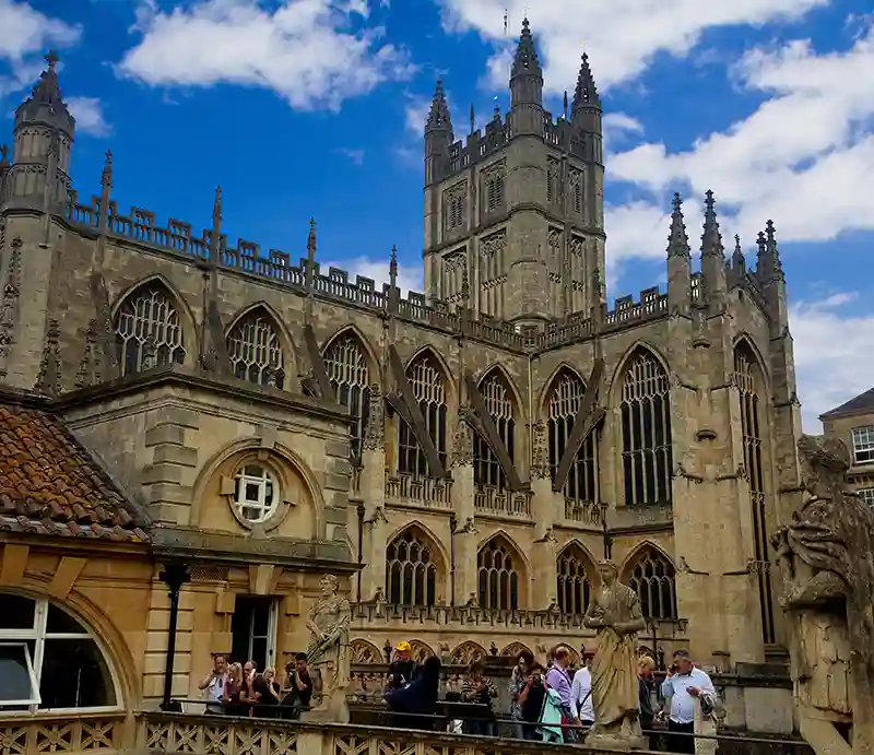 Bath Abbey Gothic style exterior and statues to foreground.