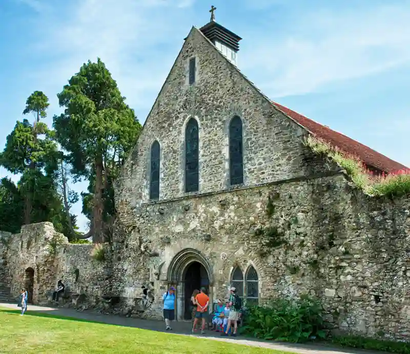 Visitors viewing the stone-built medieval refectory.
