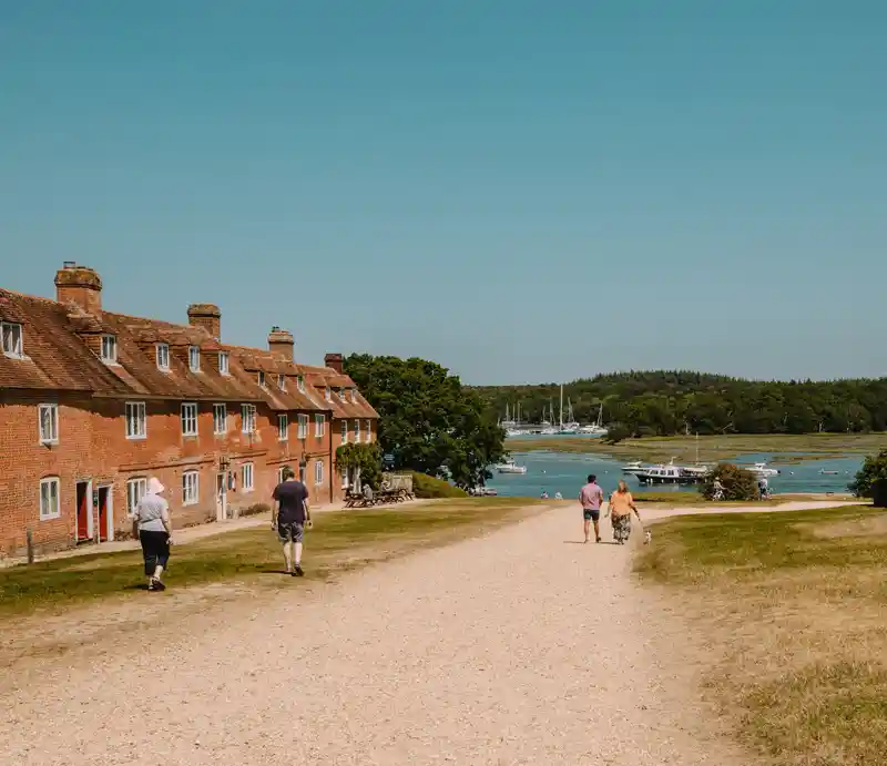 Buckler Red-brick fisherman's cottages along causeway down to the sea.