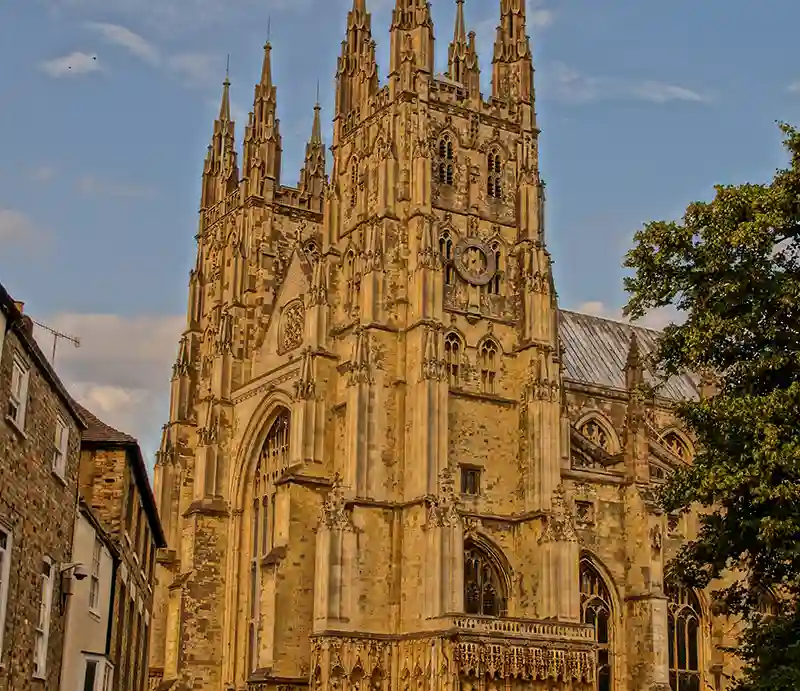 Three-quarter view of towers and spires with ornate carvings.