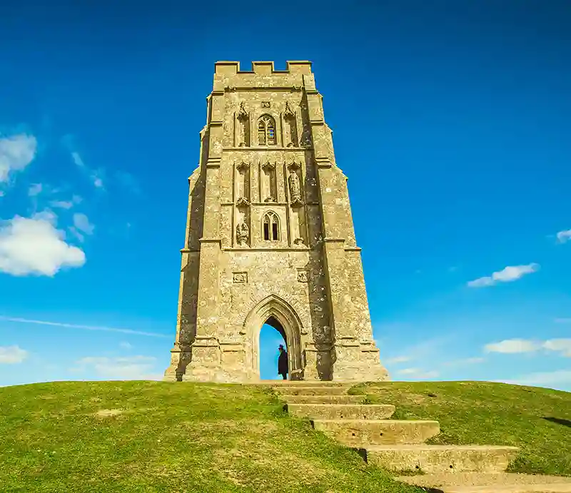 Glastonbury Tor The tower atop the hill with blue sky.
