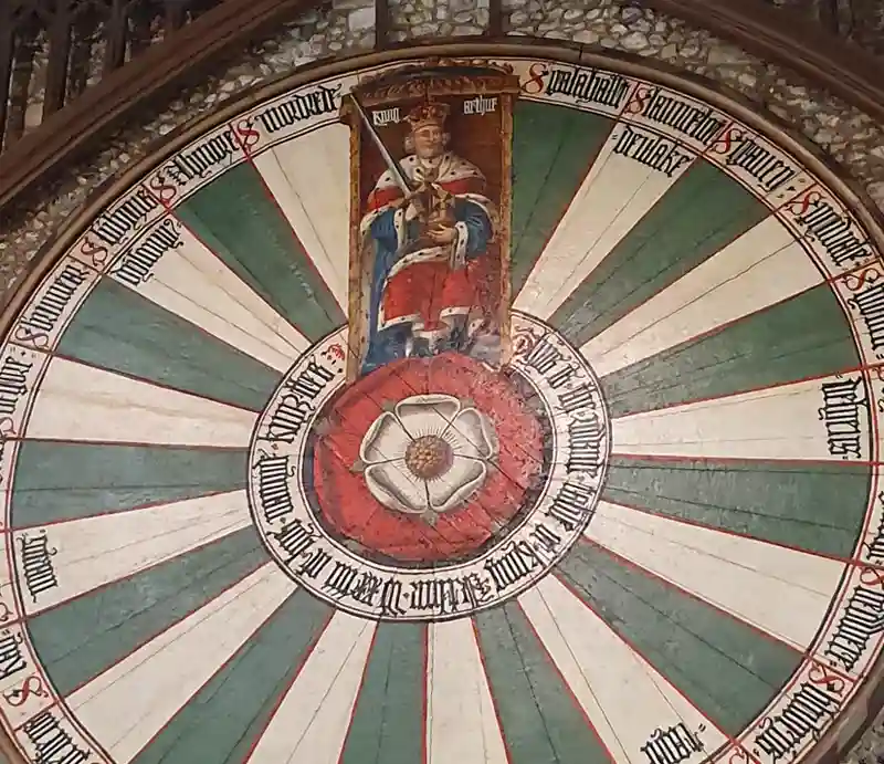 Radiating outwards from a central red and white Tudor rose alternating stripes of white and green below a portrait of an enthroned king in ceremonial robes.