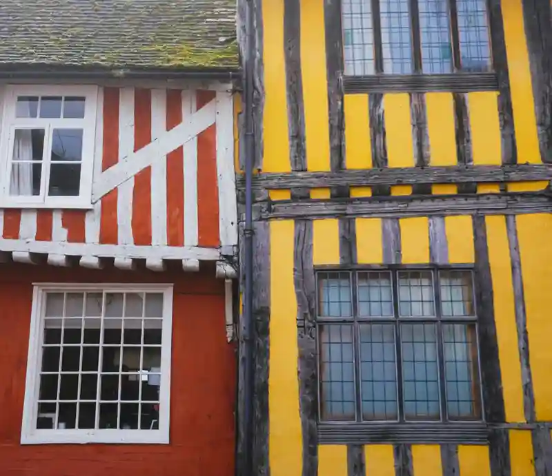 Medieval cottages Timber framed houses painted red and yellow.