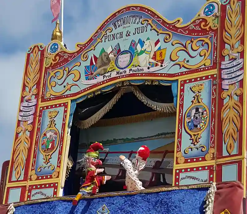 Punch & Judy show Booth with puppets on beach.