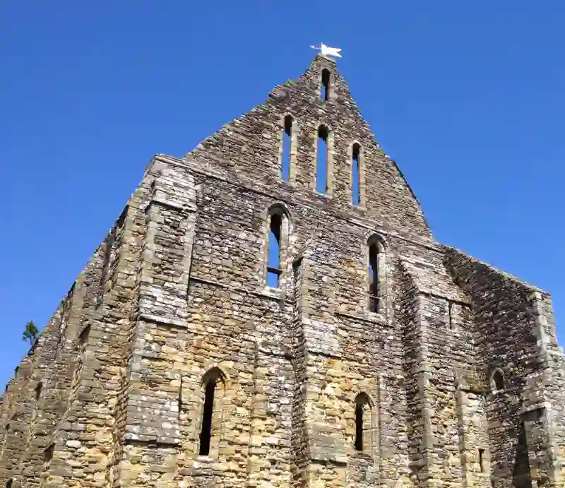 Battle Abbey The ruins against a bright blue sky.