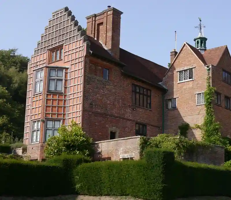 The red brick exterior built in a vernacular style.