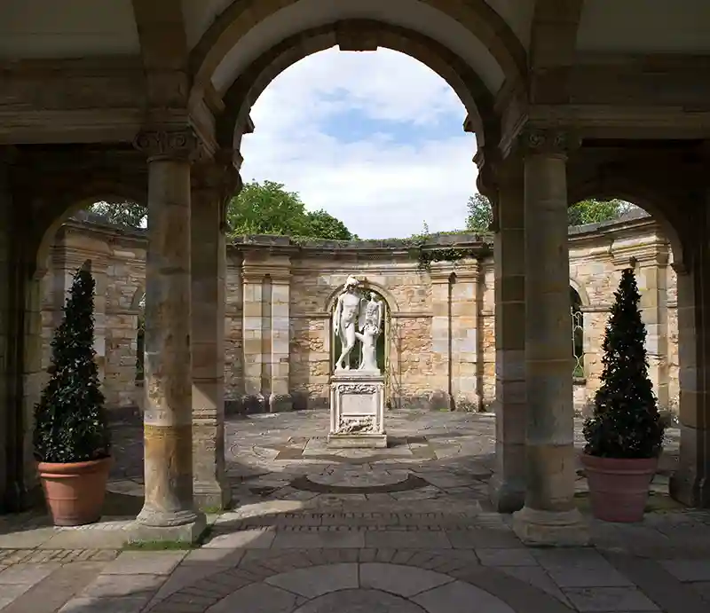 Sculpture through an ornate archway.
