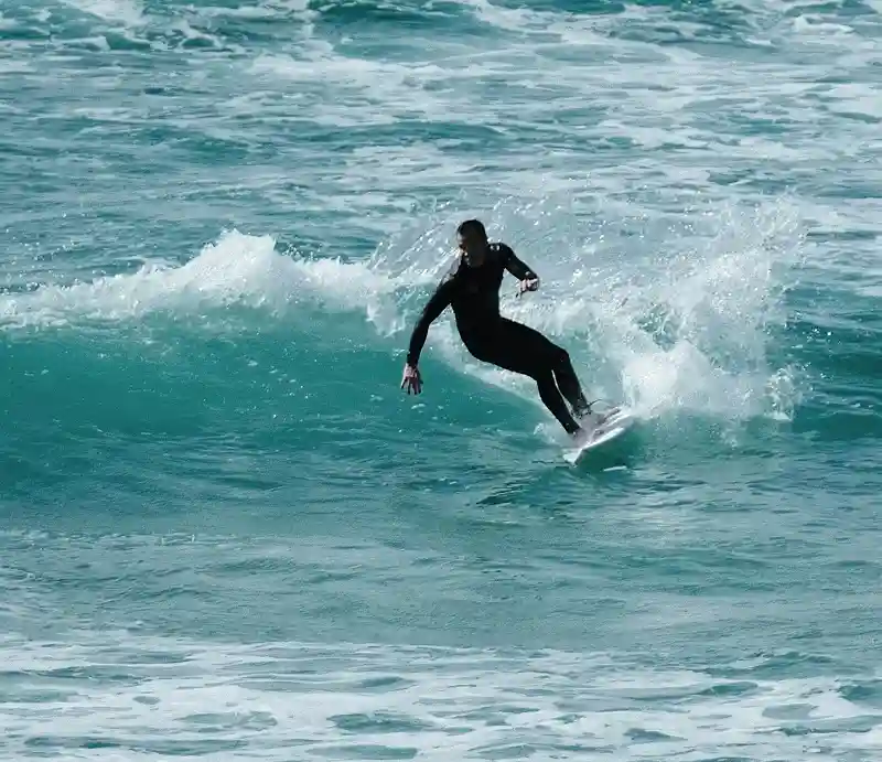 Newquay Surfer riding a wave.