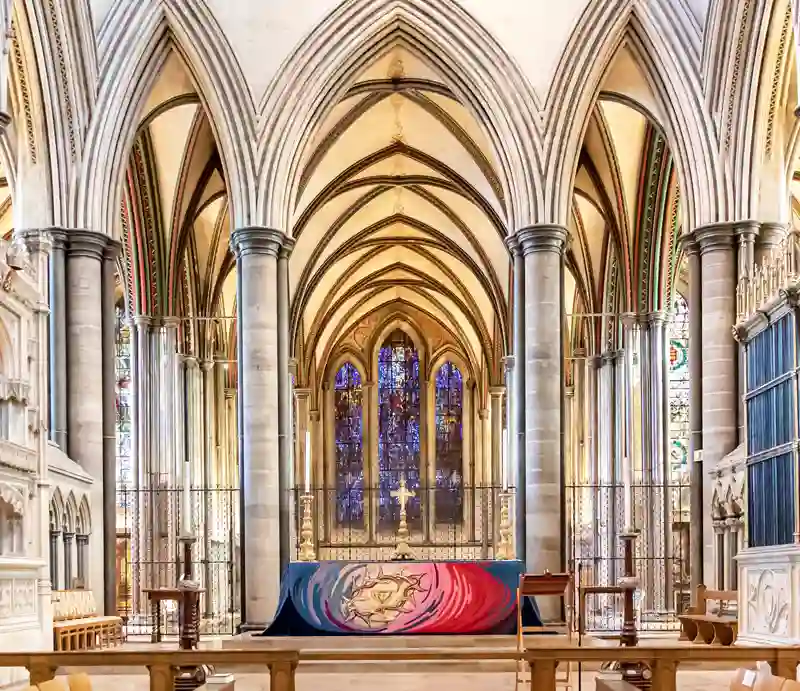 Salisbury Cathedral interior Down the main aisle towards the alter with columns and arches.