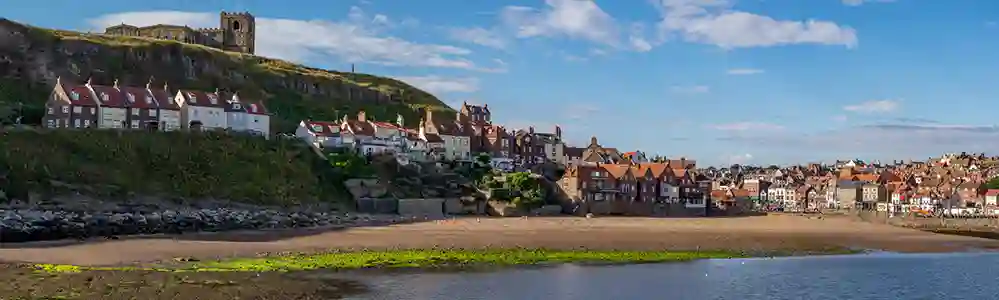 Whitby Whitby Harbour with the Gothic abbey atop the cliff.