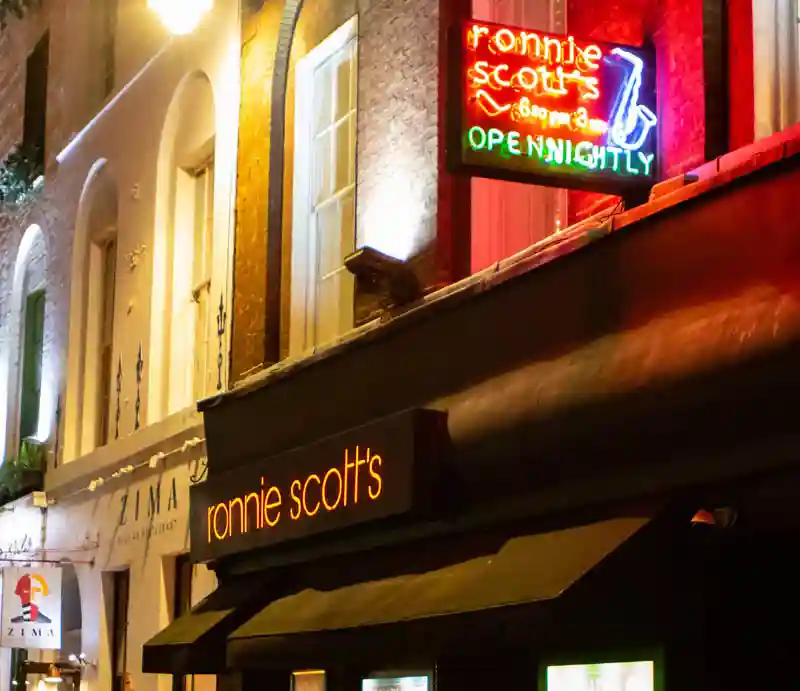Ronnie Scott Exterior of the jazz club with illuminated signs.