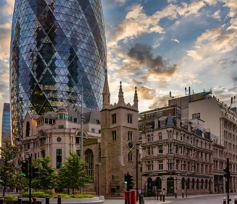 St Mary Axe The olds church on the corner with the Gherkin skyscraper towering behind.
