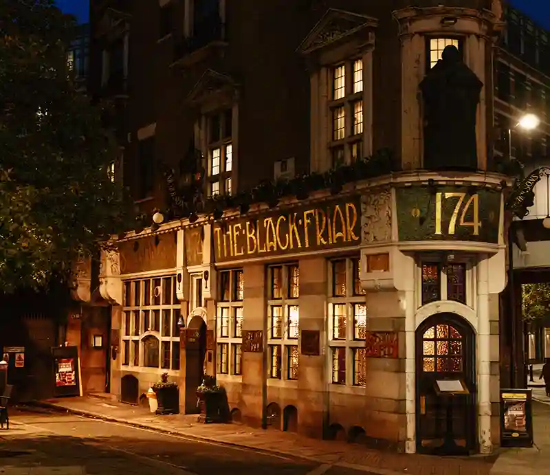 The Blackfriar public house The Victorian frontage lit up at night.