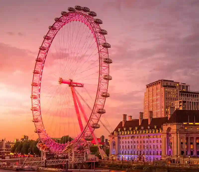 London Eye Giant ferris wheel against an orange sky.