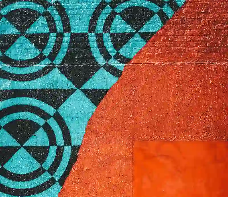 Geometric blue and black circle on bright red background.