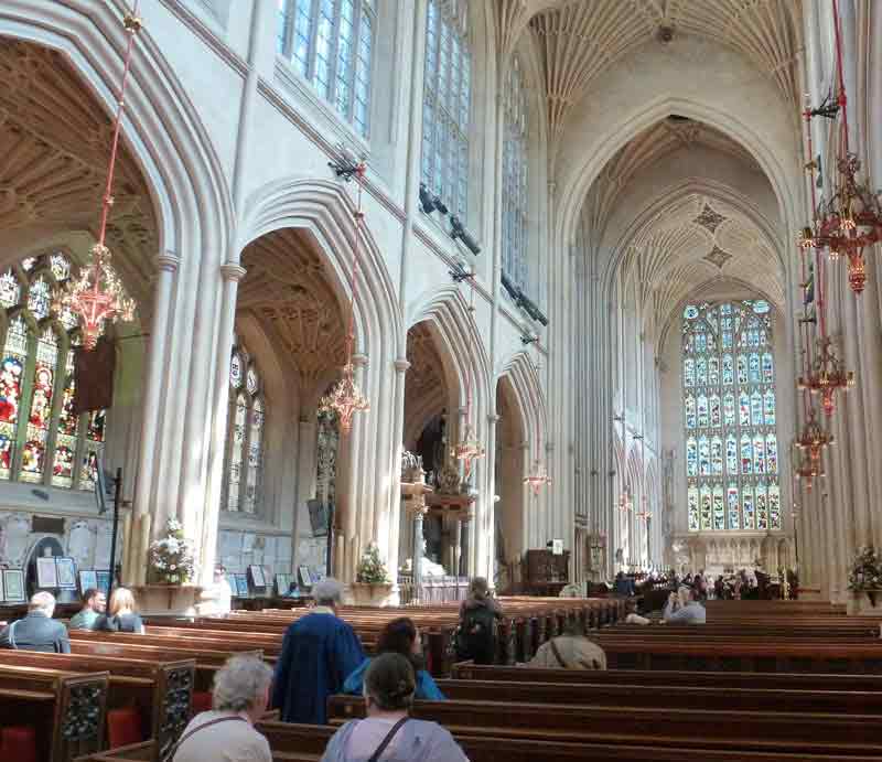 Bath Abbey Interior towards the stained glass window and altar at the eastern end of the nave.