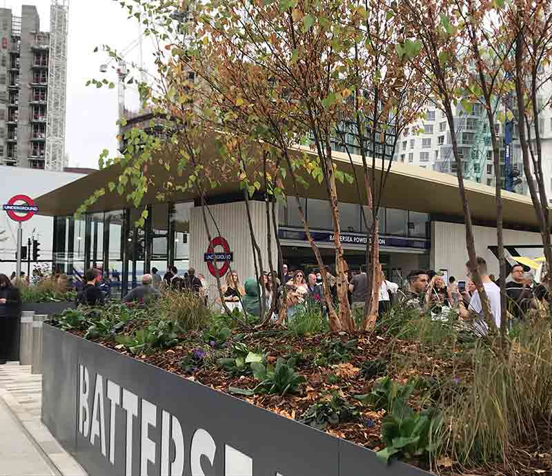 The new ungerground station through newly planted trees.