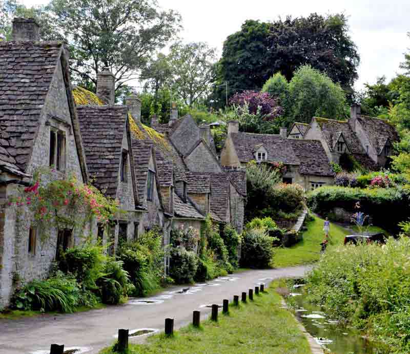 Cotswolds Tour Picturesque village lane with cottages.