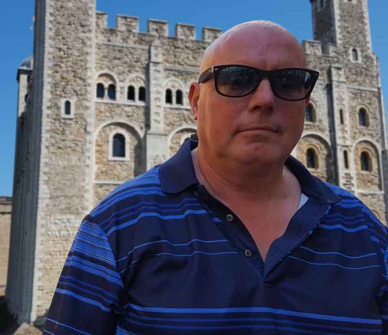 Dave Stubbs Outside the Tower of London on a bright sunny day.