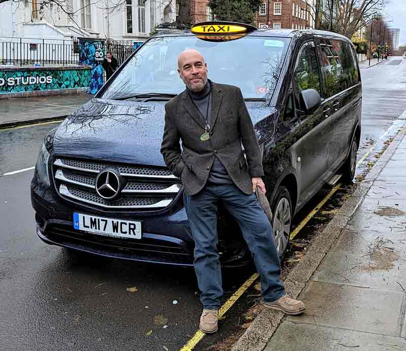 Graham Greenglass Standing by his London Black Cab.