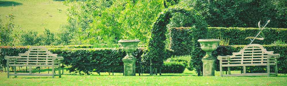 Highclere Castle gardens Benches and and topiary borders.