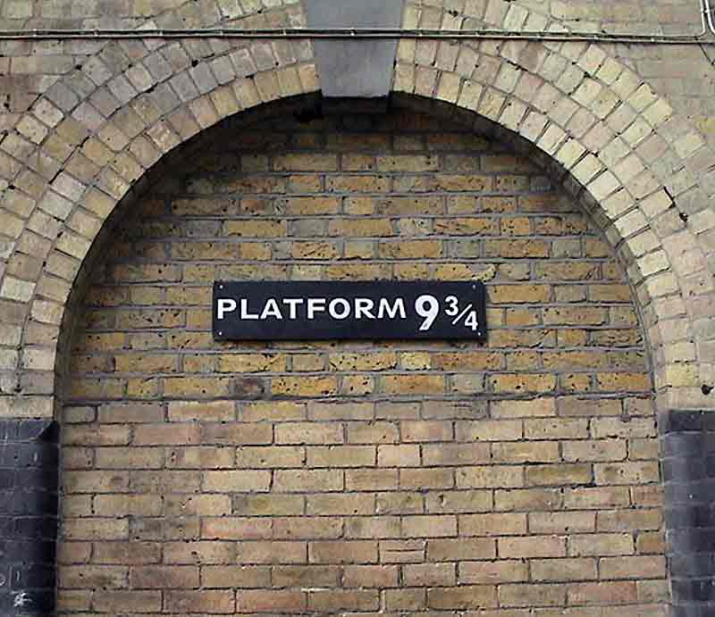 The Platform 9¾ sign within  yellow-brick arch.