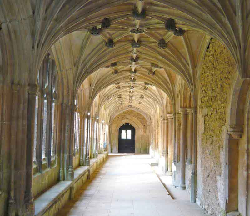 Lacock Abbey Looking down the sunlit cloisters.