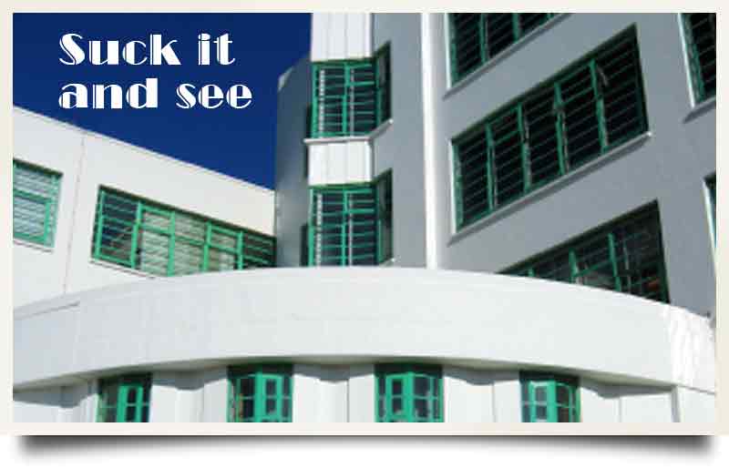 Hoover Building tours postcard Art deco exterior with caption 'Suck it and see'.