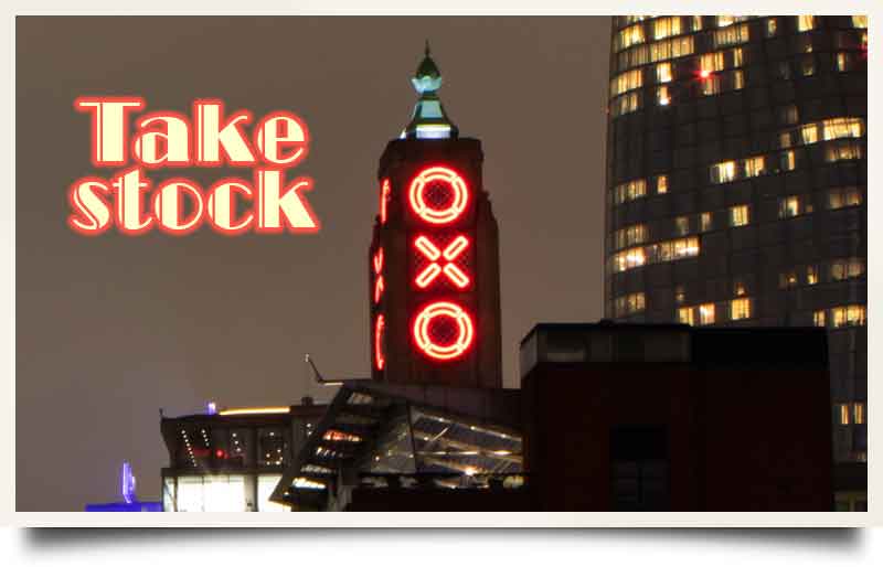 Oxo Tower tours postcard Illuminated at night with caption 'Take stock' in an art deco font.