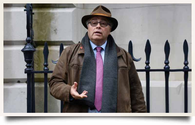 Guiding in Harley Street wearing suit, leather jacket, scarf and pink tie