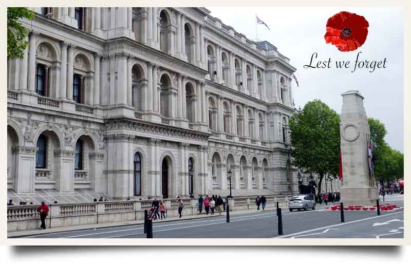 Whitehall tours postcard The Cenotaph with illustration of poppy and caption 'Lest we forget'.