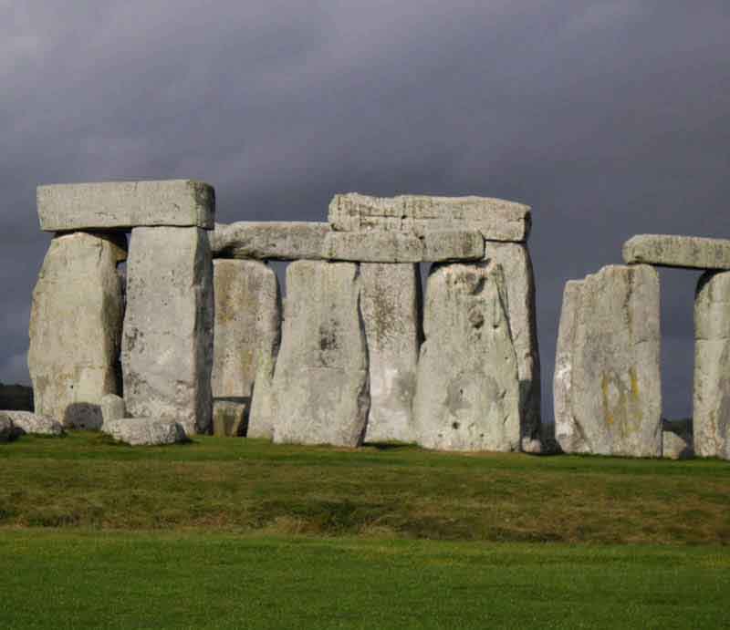 Sarsen stones beneath a dramatic grey sky.